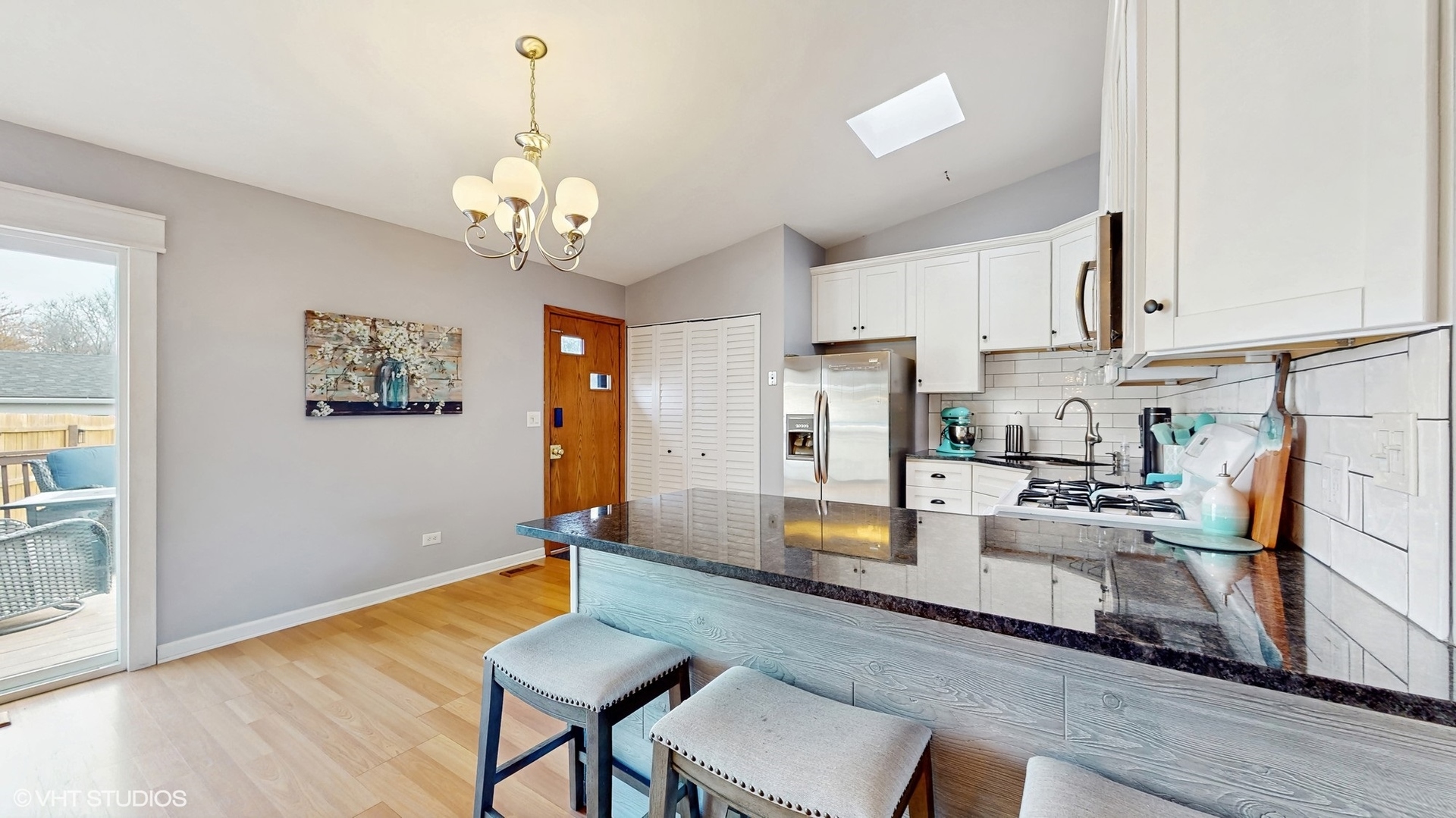2206 Oak Lane Rolling Meadows, IL 60008 - Photo 7 of 24 a view of a dining room with furniture a chandelier and wooden floor