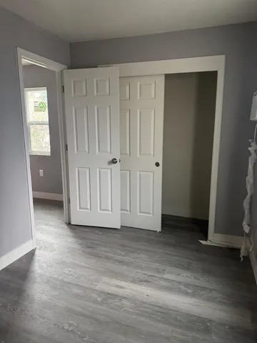 a view of a room with wooden floor