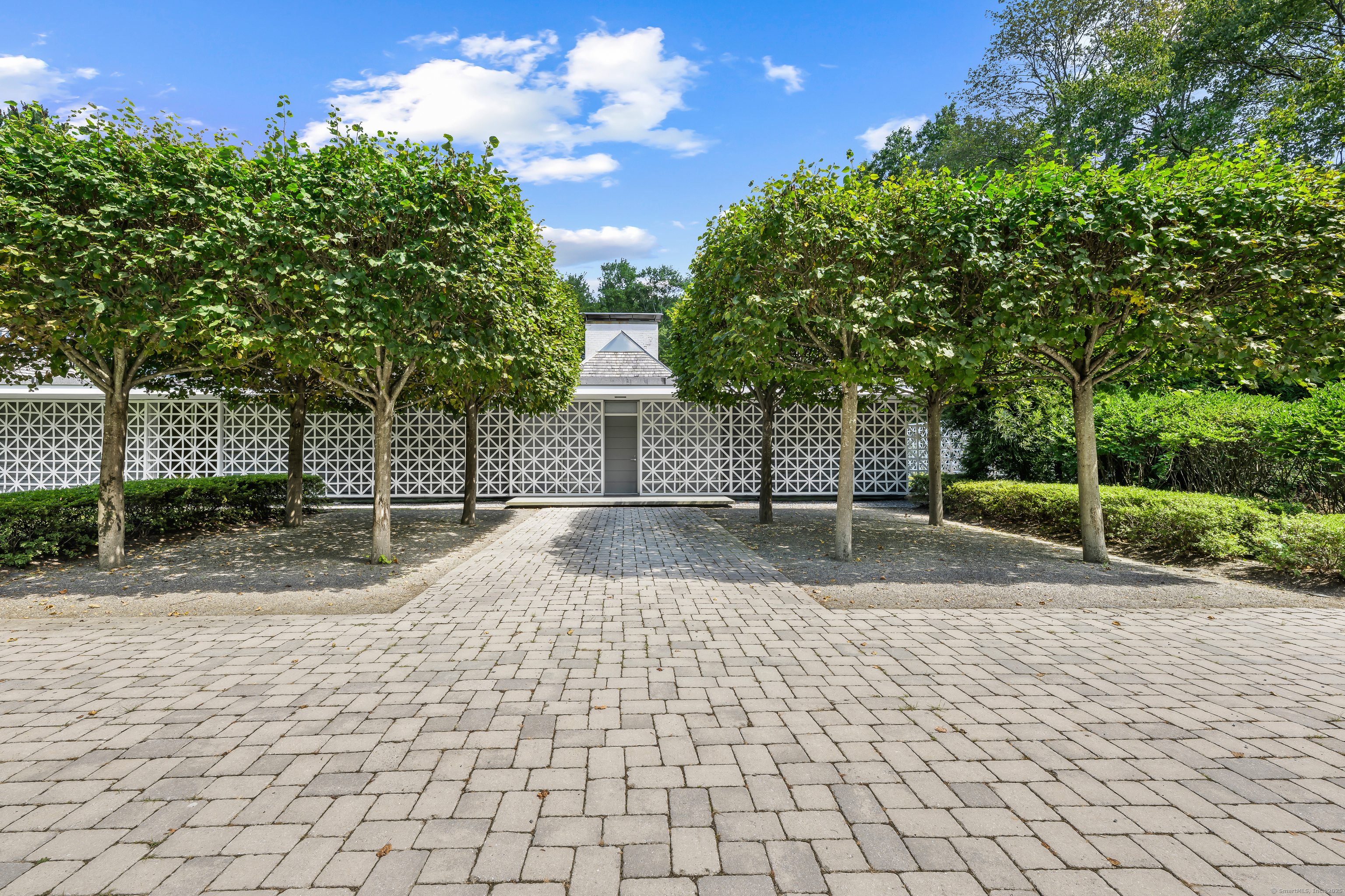 565 Oenoke Ridge New Canaan, CT 06840 - Photo 1 of 39 a view of a yard with plants and trees
