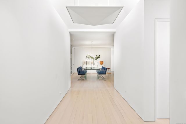 a view of a dining room with furniture and a chandelier