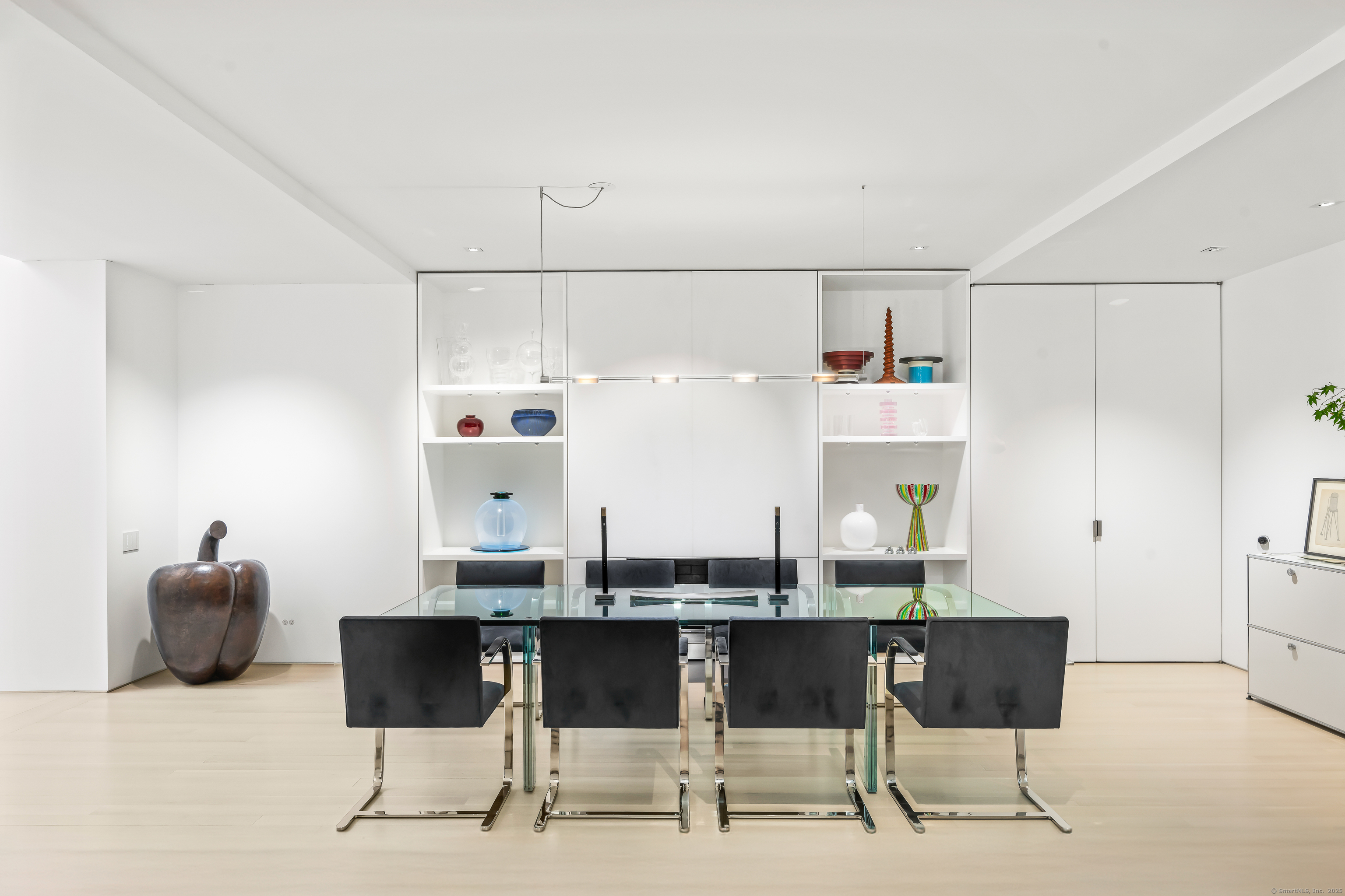 565 Oenoke Ridge New Canaan, CT 06840 - Photo 13 of 39 a kitchen with a dining table chairs and white cabinets