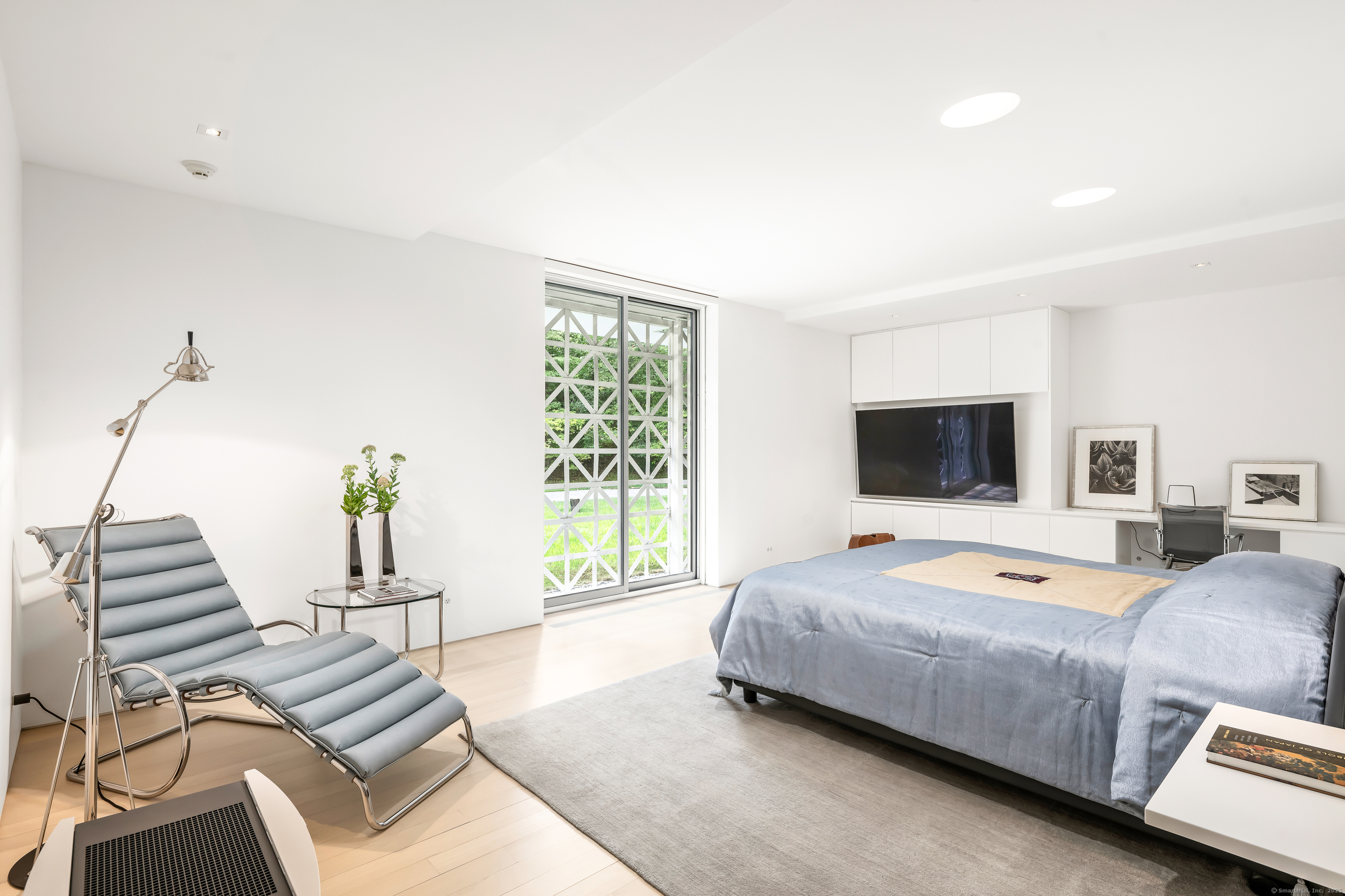 565 Oenoke Ridge New Canaan, CT 06840 - Photo 18 of 39 a bedroom with a bed and a television