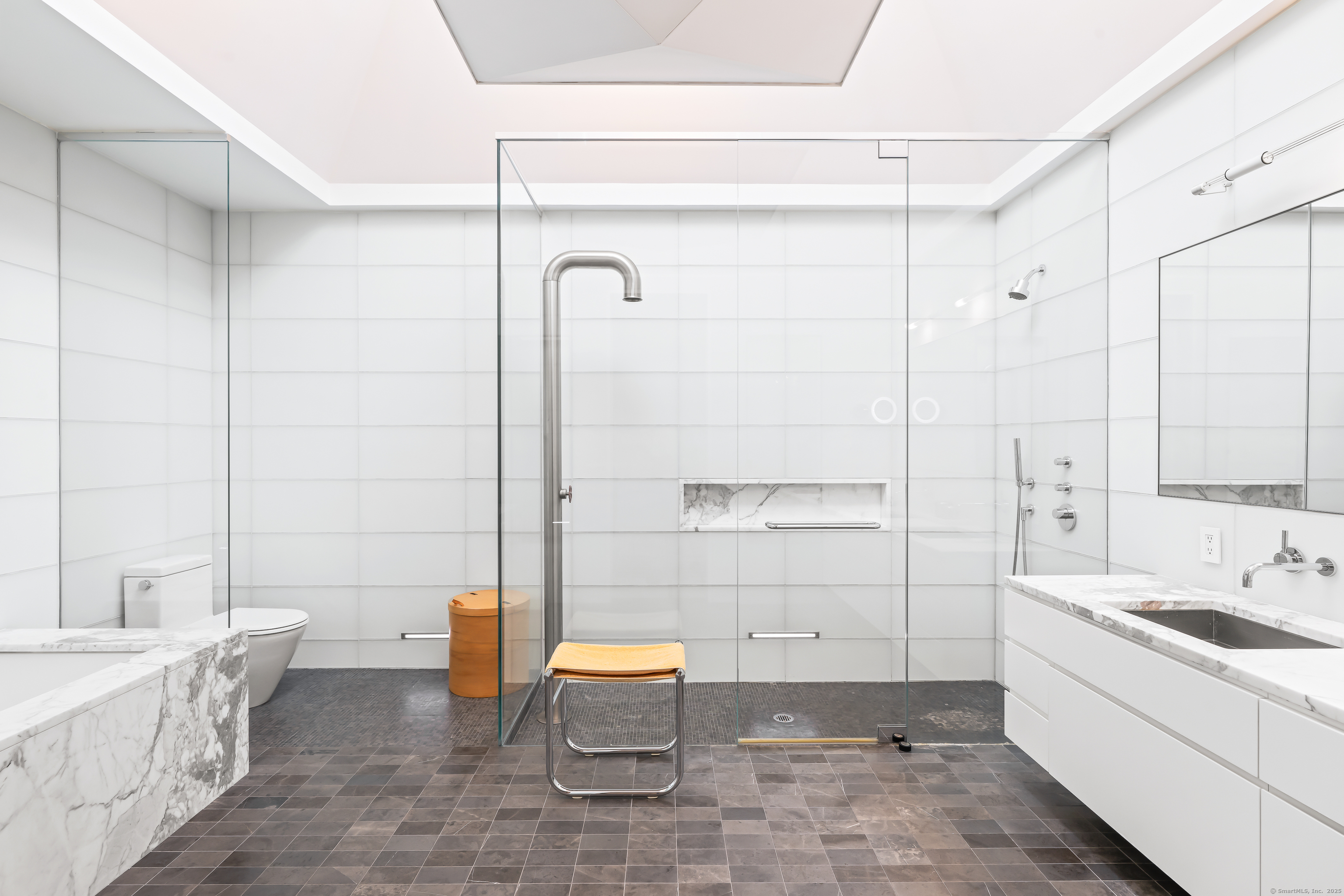 565 Oenoke Ridge New Canaan, CT 06840 - Photo 19 of 39 a bathroom with a sink and a mirror