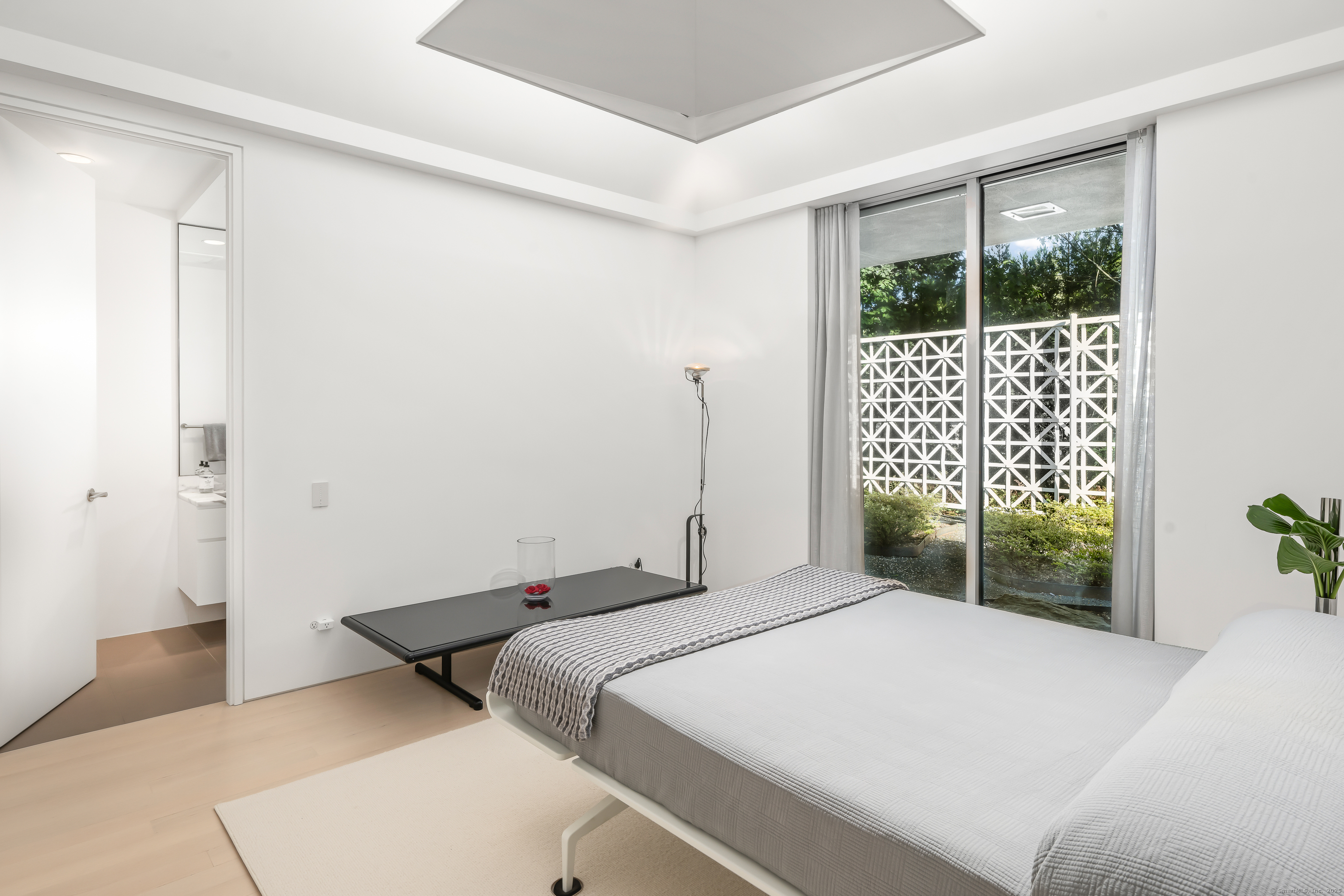 565 Oenoke Ridge New Canaan, CT 06840 - Photo 20 of 39 a bedroom with a bed and a window