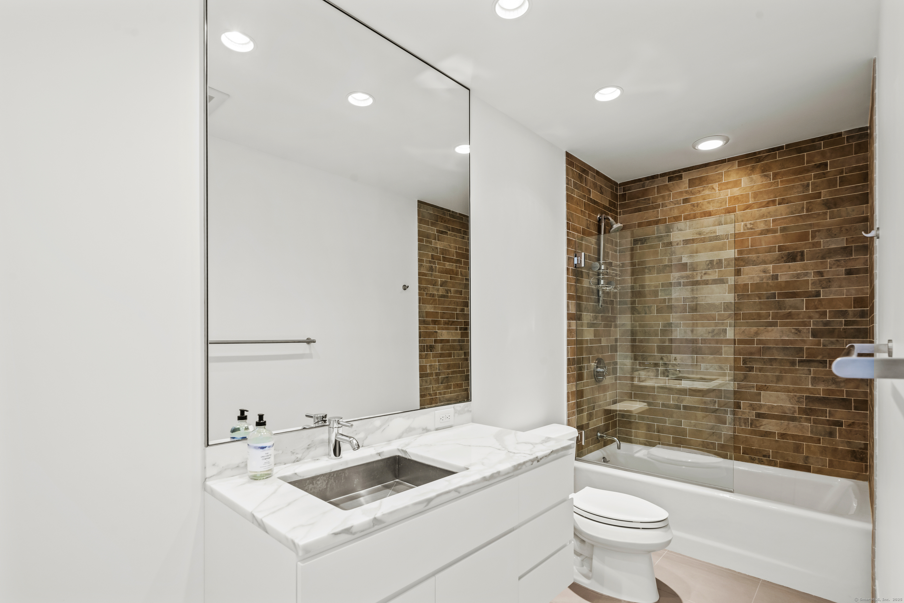 565 Oenoke Ridge New Canaan, CT 06840 - Photo 21 of 39 a bathroom with a sink toilet tub and shower