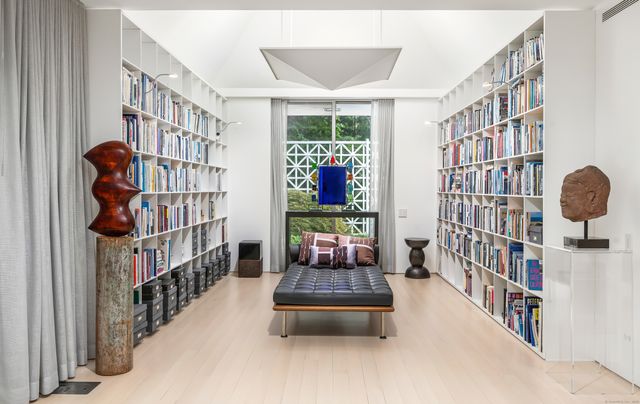 a bedroom with furniture and a book shelf