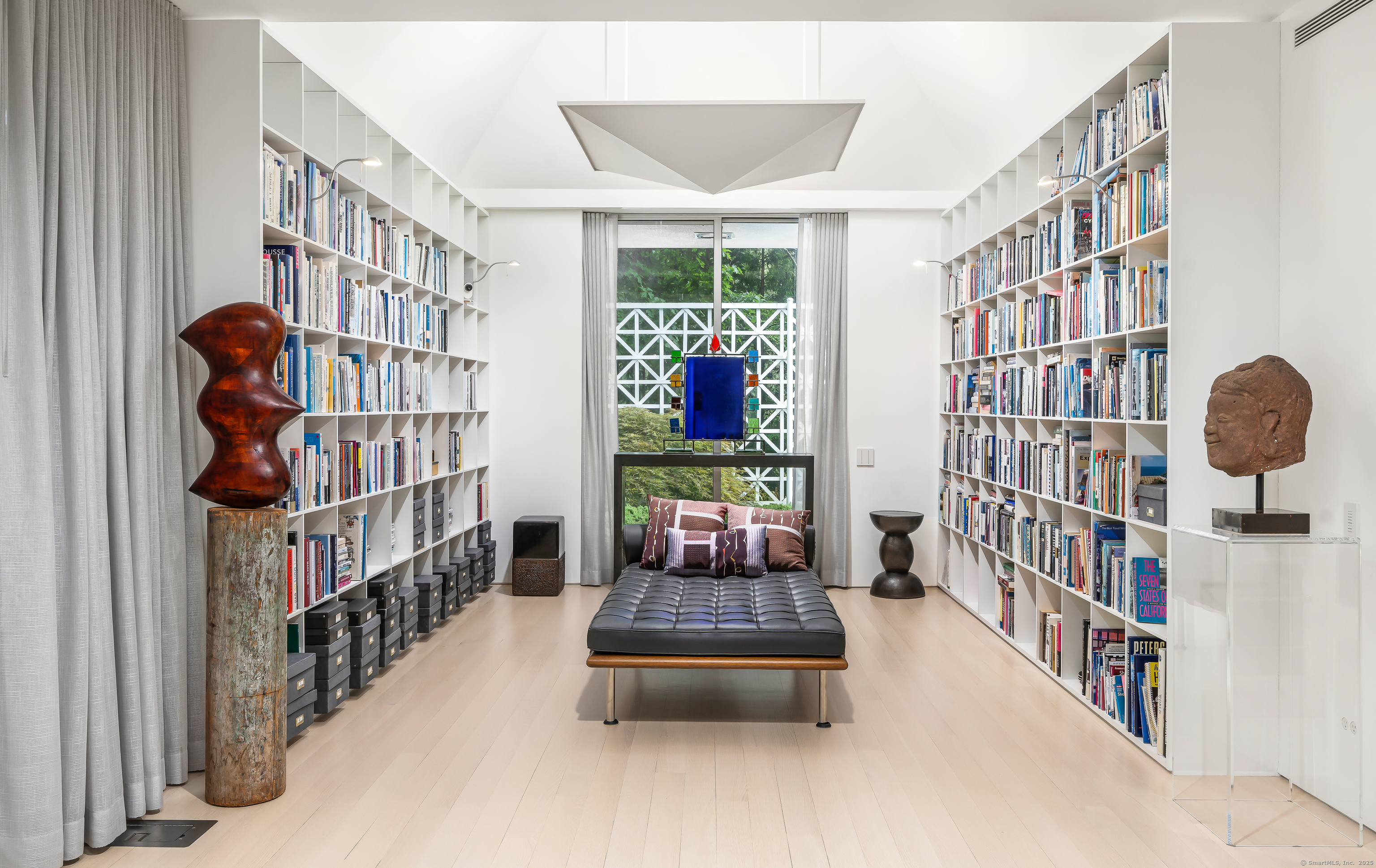 565 Oenoke Ridge New Canaan, CT 06840 - Photo 8 of 39 a bedroom with furniture and a book shelf