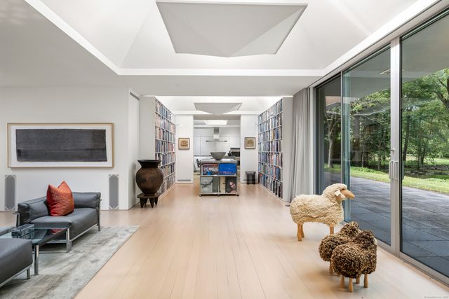 a living room filled with furniture and a large window