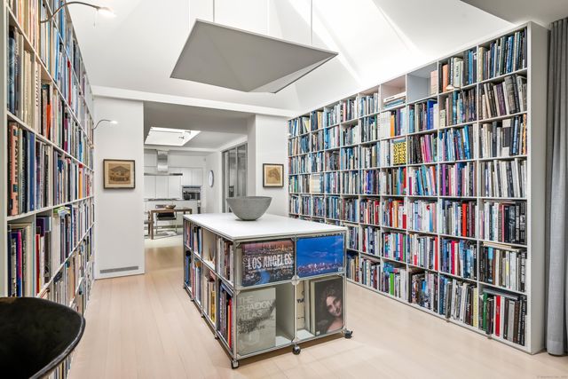 a living room with lots of books