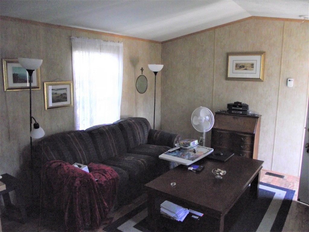 51 Monson Turnpike Road, Unit 1054 Ware, MA 01082 - Photo 15 of 23 a living room with furniture and a window