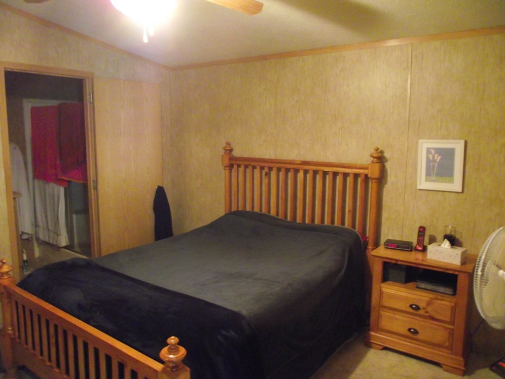 51 Monson Turnpike Road, Unit 1054 Ware, MA 01082 - Photo 5 of 23 a bedroom with a bed and a window
