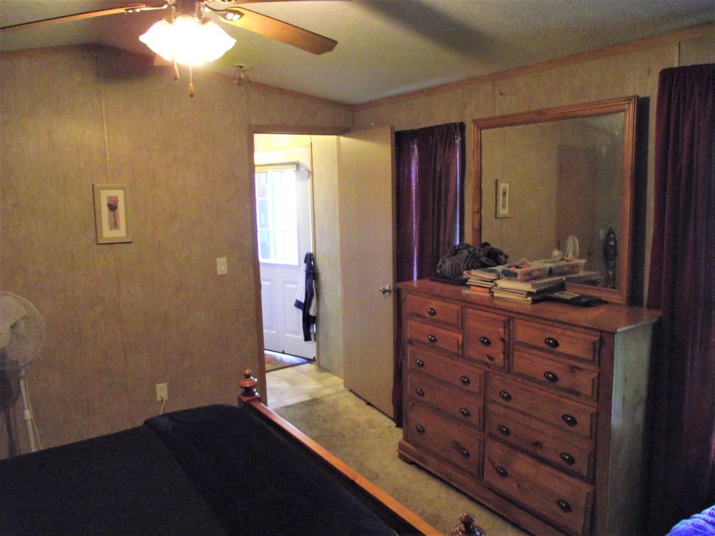 51 Monson Turnpike Road, Unit 1054 Ware, MA 01082 - Photo 6 of 23 a room with a dresser and a mirror