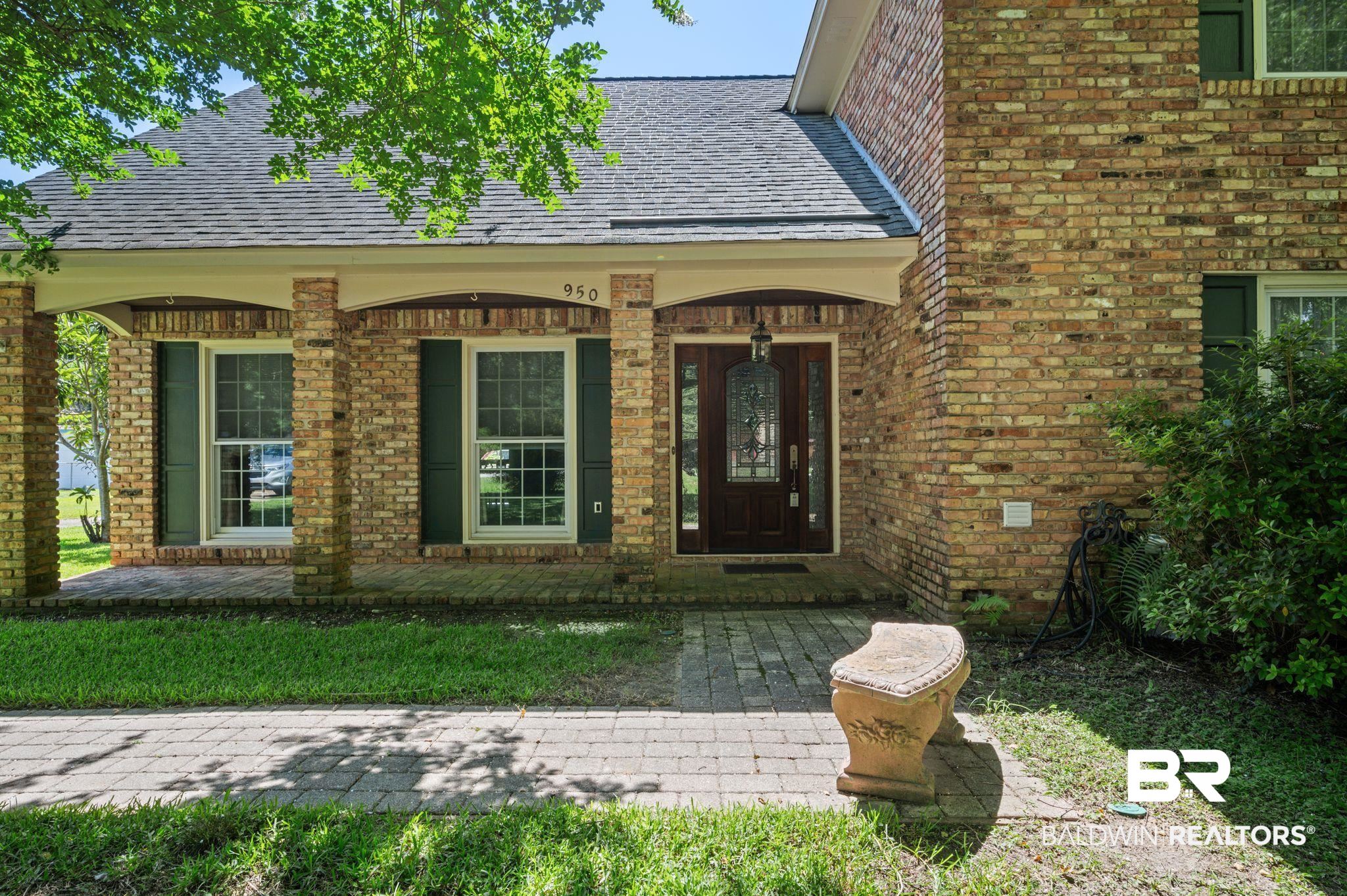 950 Walter Smith Road Mobile, AL 36695 - Photo 2 of 51 Doorway to property featuring a shingled roof, brick siding, and covered porch
