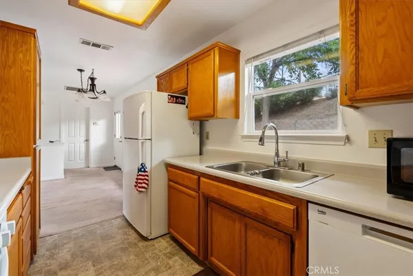 a kitchen with refrigerator and cabinets