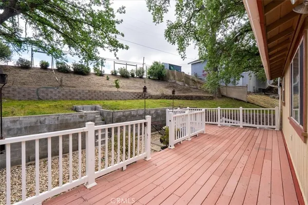 a view of deck with wooden floor and trees