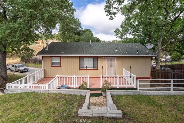 a front view of a house with a yard fire pit and outdoor seating