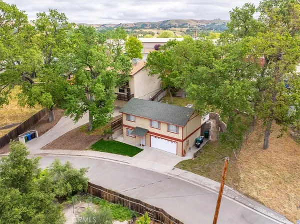 an aerial view of a house with a yard basket ball court and outdoor seating