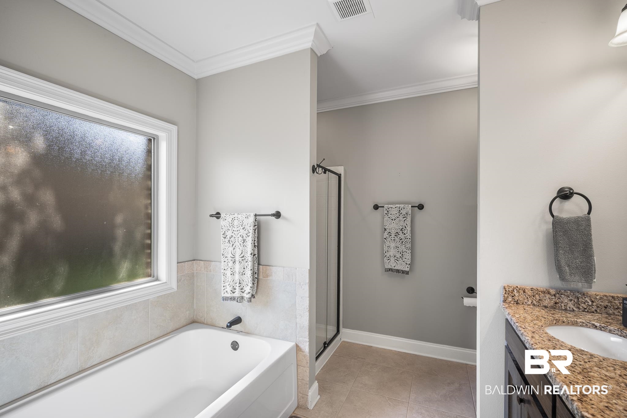 8594 Rosedown Lane Daphne, AL 36526 - Photo 20 of 30 Bathroom with a soaking tub, double vanity, and a separate shower