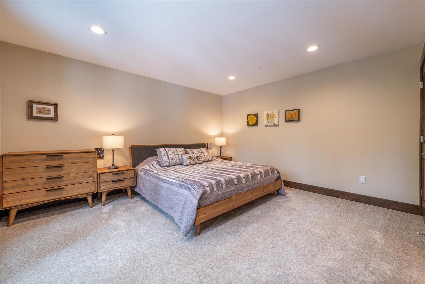 13846 Pathway Avenue Truckee, CA 96161 - Photo 23 of 28 a spacious bedroom with a bed and a dresser
