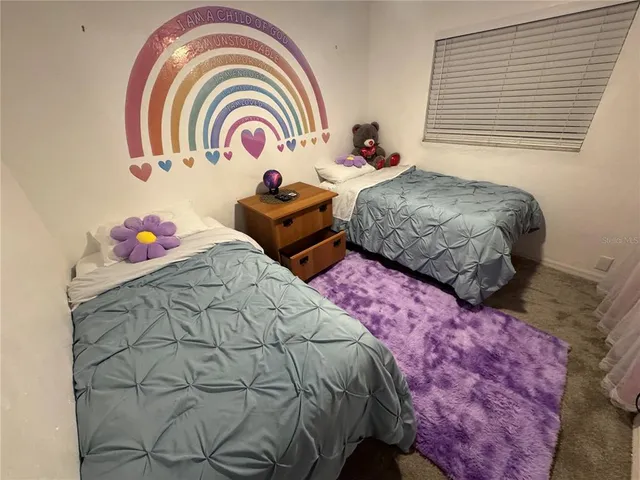 a bedroom with bed and a window