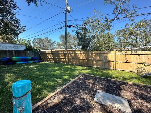 a view of a backyard with plants and a garden