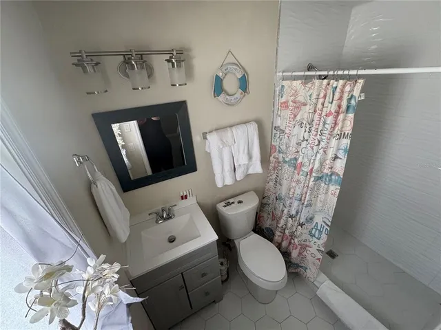 a white toilet sitting next to a bathroom sink