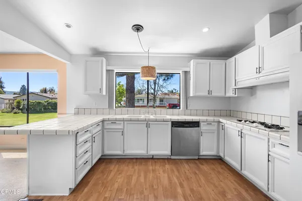 a kitchen with a sink window and cabinets