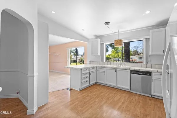 a kitchen with a refrigerator and a stove top oven
