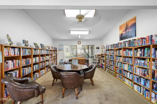 a living room with furniture and a book shelf
