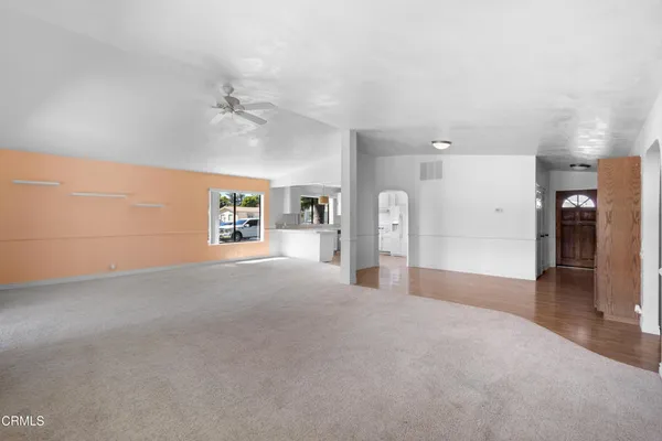 a view of a big room with closet and windows