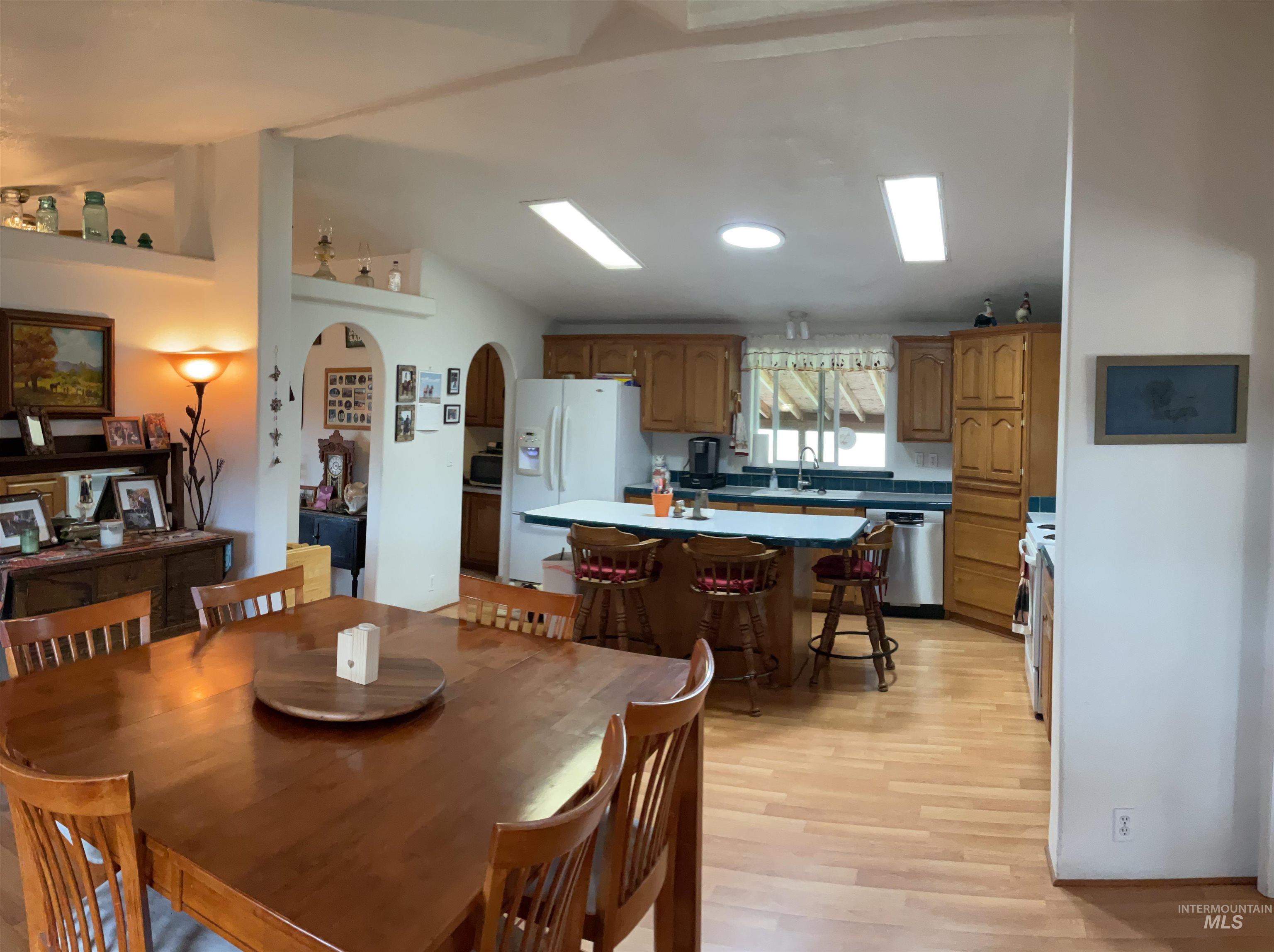 10749 Upper Fords Creek Road Orofino, ID 83544 - Photo 35 of 45 Dining room featuring arched walkways, light wood-type flooring, and lofted ceiling