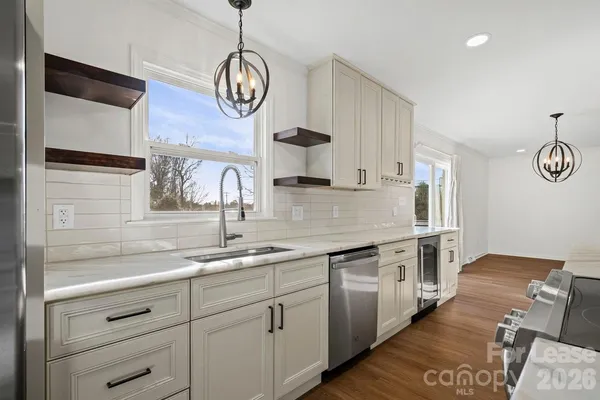 a kitchen with cabinets and wooden floor