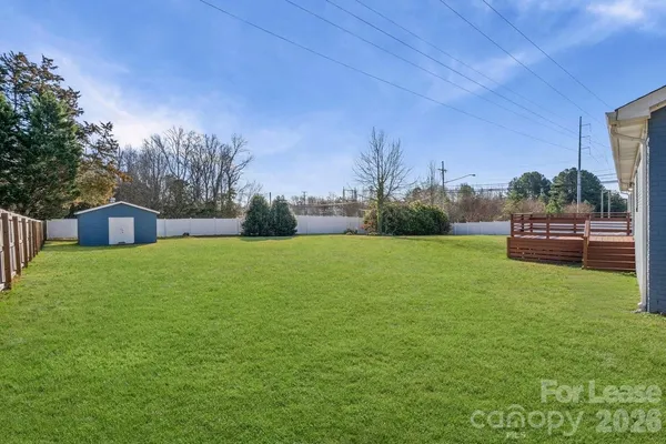 a view of house with backyard