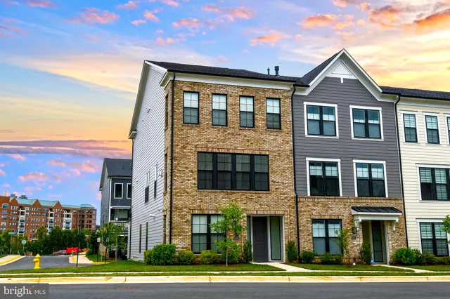a front view of a residential apartment building with a yard