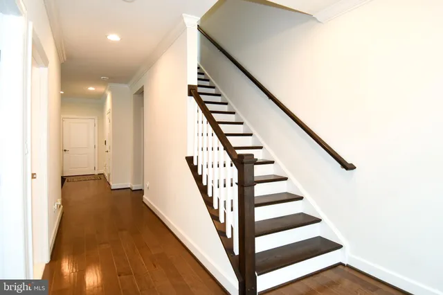 a view of entryway and hall with wooden floor