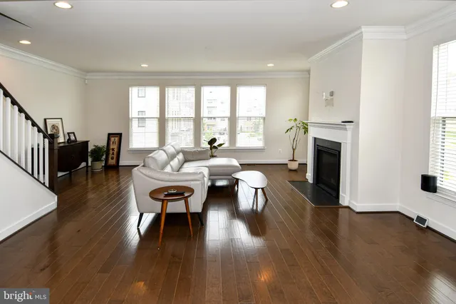 a living room with fireplace furniture and a wooden floor