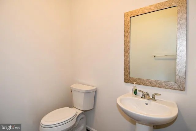 a bathroom with a sink a mirror and a toilet