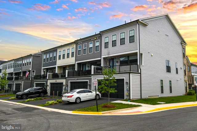 a view of a house with swimming pool and sitting area