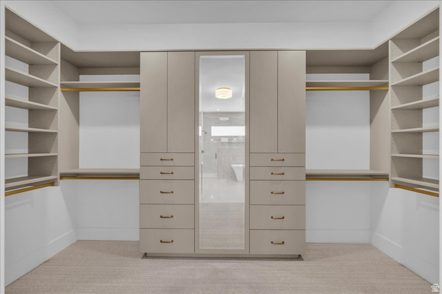 1620 Belayer Drive St. George, UT 84770 - Photo 24 of 51 Custom closet system featuring built-in cabinetry, shelving, hanging rods, and a mirrored panel