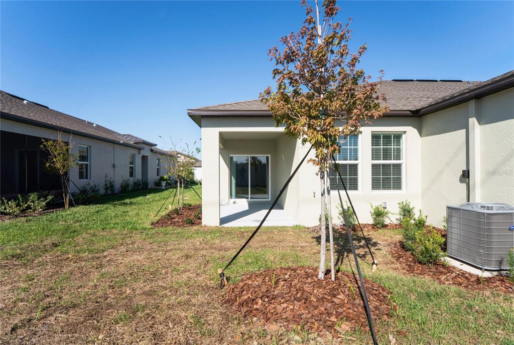 6692 Homebound Way New Port Richey, FL 34653 - Photo 38 of 47 a house view with a garden space