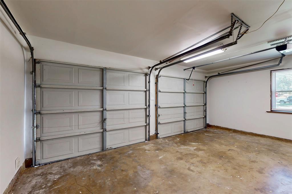1000 Springdale Road Bedford, TX 76021 - Photo 28 of 36 Two-car garage with separate garage doors. Electric opener on the right side was recently added, and the interior is freshly painted!