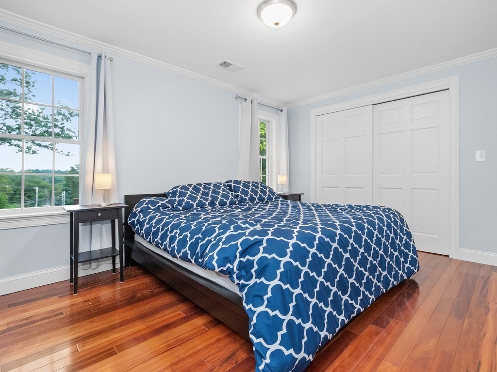 1767 Trapelo Road Waltham, MA 02451 - Photo 19 of 39 a bedroom with a bed and wooden floor