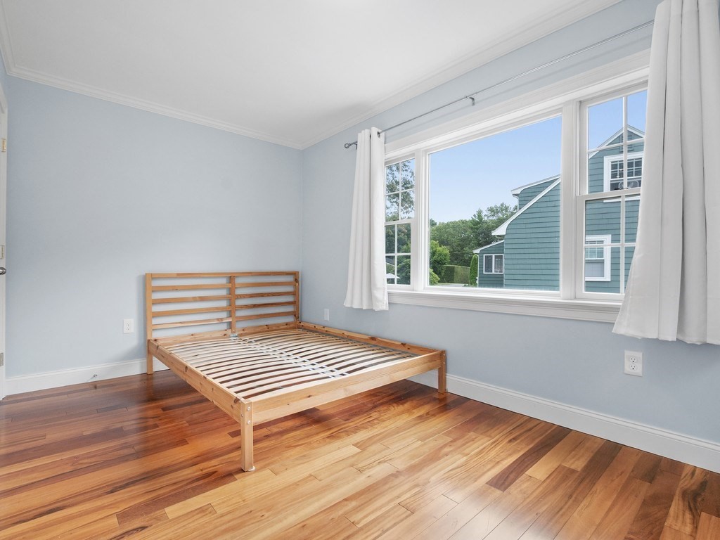 1767 Trapelo Road Waltham, MA 02451 - Photo 21 of 39 a bedroom with a bed and wooden floor
