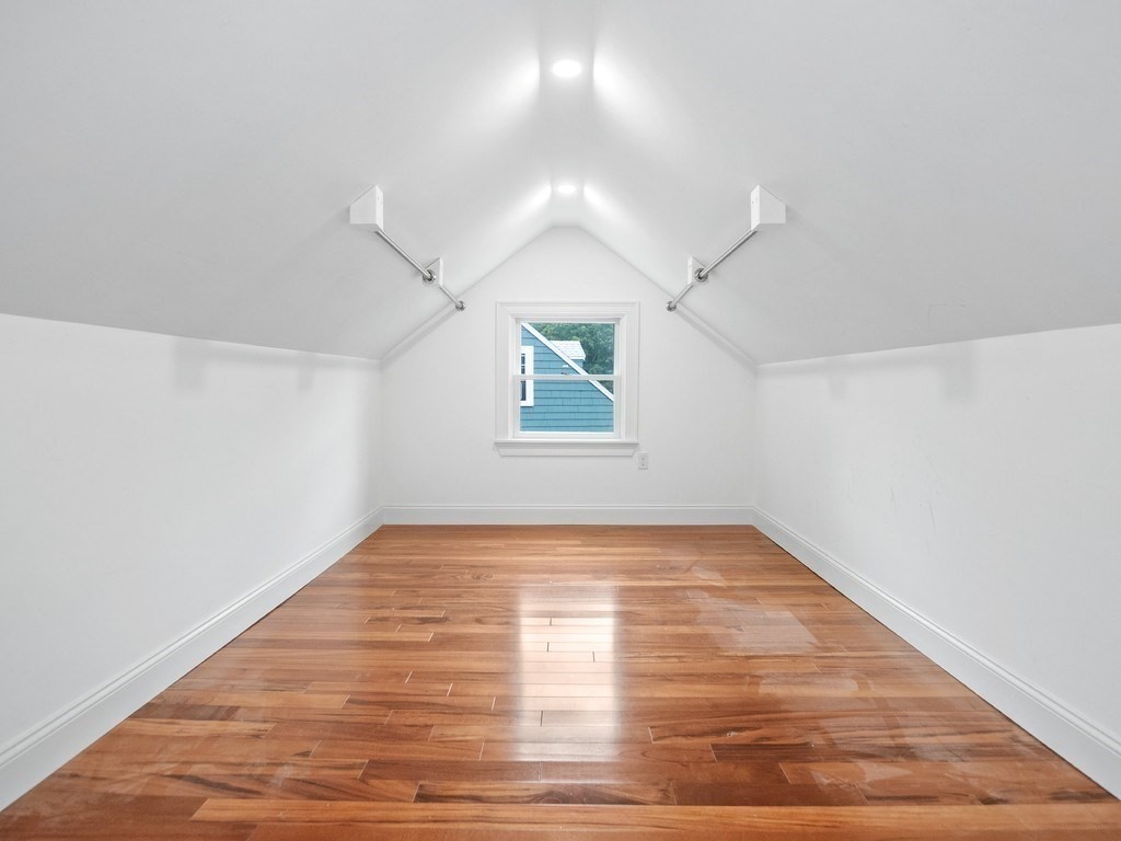 1767 Trapelo Road Waltham, MA 02451 - Photo 24 of 39 a view of an empty room with wooden floor and a window