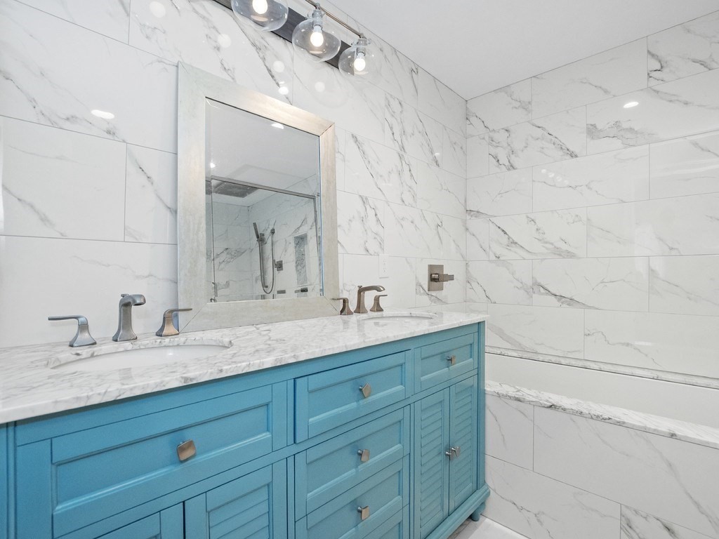 1767 Trapelo Road Waltham, MA 02451 - Photo 25 of 39 a bathroom with double vanity sink and mirror