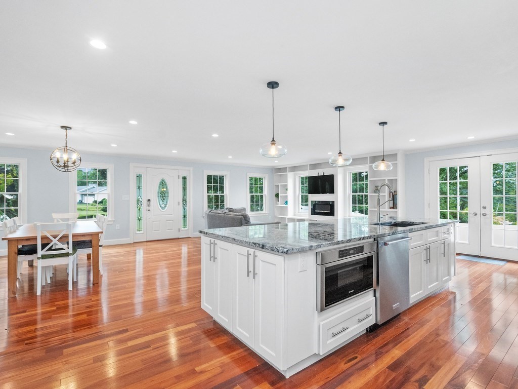 1767 Trapelo Road Waltham, MA 02451 - Photo 4 of 39 a large kitchen with stainless steel appliances granite countertop a stove and cabinets