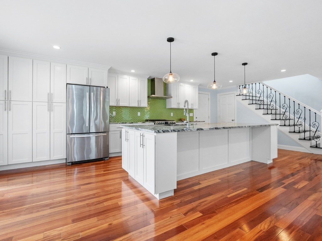 1767 Trapelo Road Waltham, MA 02451 - Photo 5 of 39 a kitchen with stainless steel appliances granite countertop a refrigerator a oven and a wooden floors
