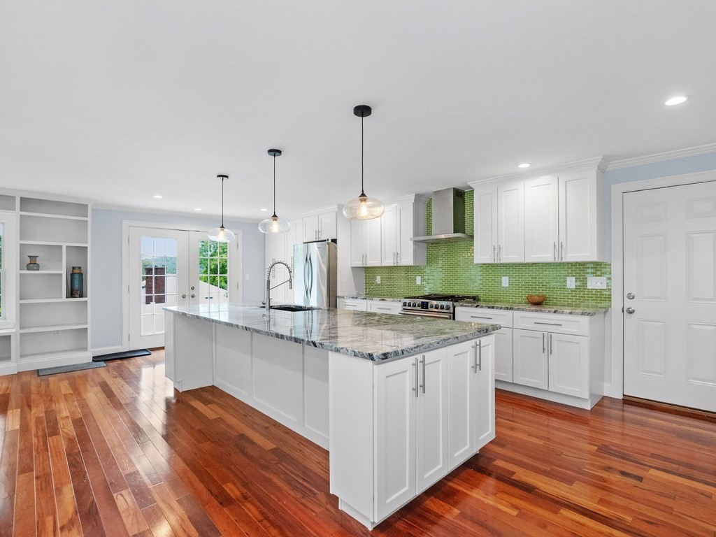 1767 Trapelo Road Waltham, MA 02451 - Photo 8 of 39 a large kitchen with kitchen island white cabinets and stainless steel appliances
