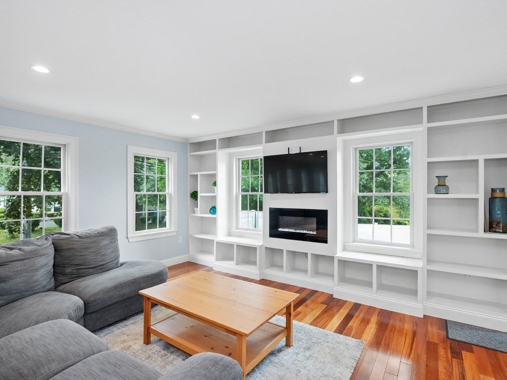 1767 Trapelo Road Waltham, MA 02451 - Photo 10 of 39 a living room with furniture a flat screen tv and a fireplace