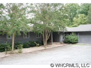 300 Upper Ridgeview Road Columbus, NC 28722 - Photo 1 of 12 a house with a tree in front of it